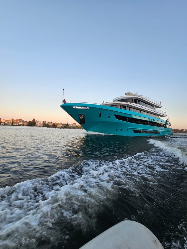 The bow of SARAH & MO 2 cutting through the Red Sea, seen from a tender in her wake.